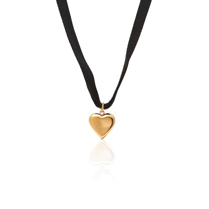 Silk & Steel cupid choker necklace in black velvet ribbon and puffed heart pendant in 14k gold-plated stainless steel.