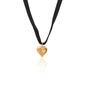 Silk & Steel cupid choker necklace in black velvet ribbon and puffed heart pendant in 14k gold-plated stainless steel.